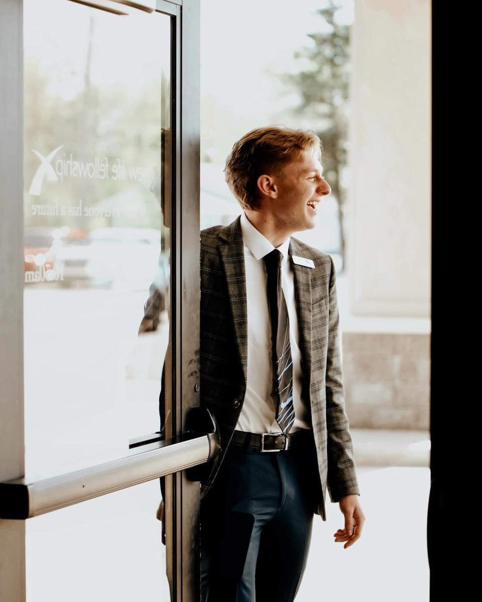 A greeter smiling at the front door