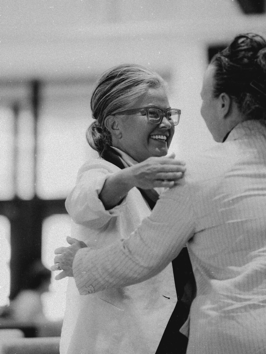 Tami Harpole laughing as she embraces someone after a service