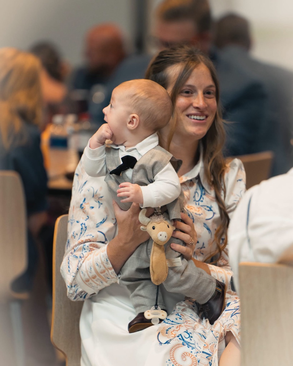 A mom laughing with her baby in the fellowship hall
