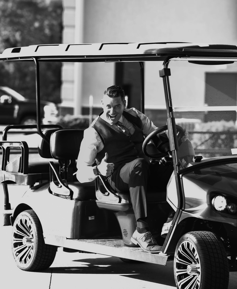 A parking team member on the golf cart, thumbs up